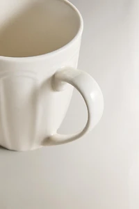 PORCELAIN MUG WITH RAISED DESIGN