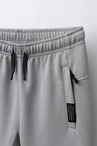PANTALON EN MOLLETON INTERLOCK ET PIQUÉ