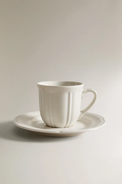 COFFEE CUP AND PORCELAIN SAUCER WITH RAISED DESIGN