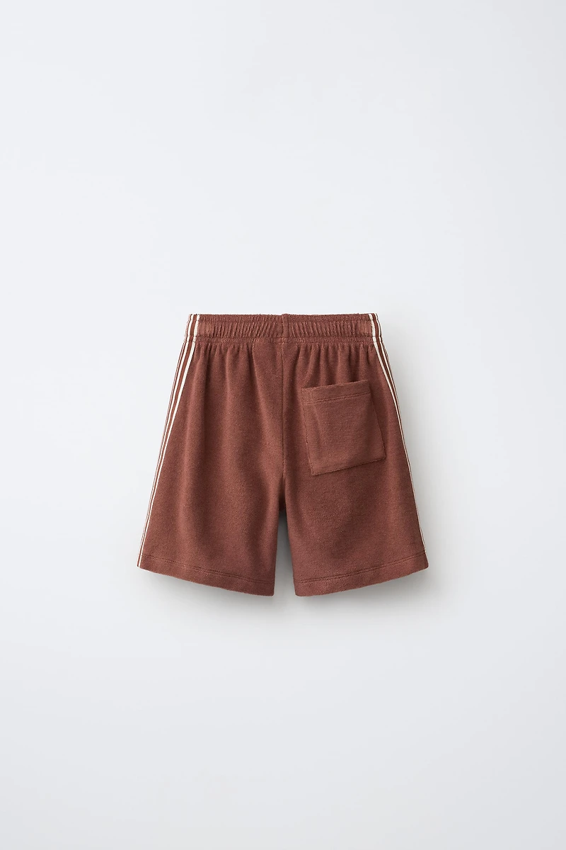 BERMUDA EN TISSU ÉPONGE PUKAS SURF