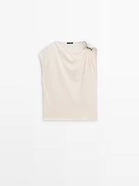 Asymmetric top with shoulder appliqué