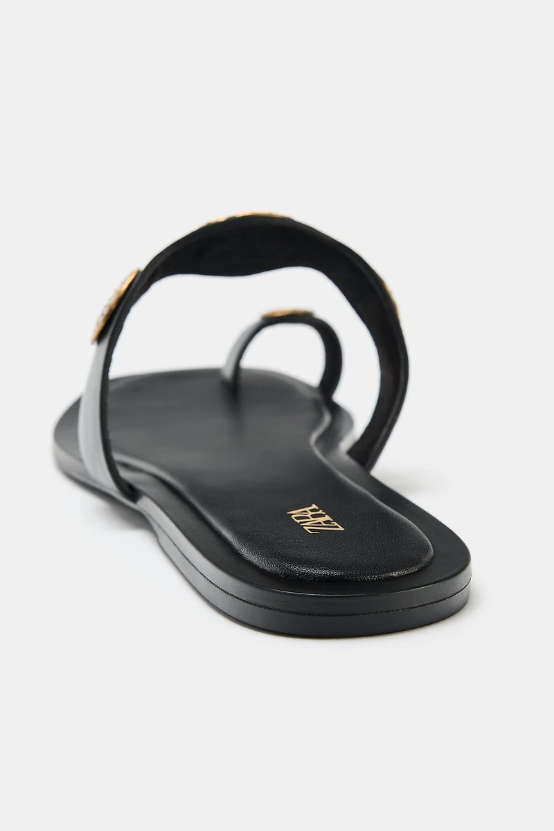 FLAT SANDALS WITH METALLIC DETAILS