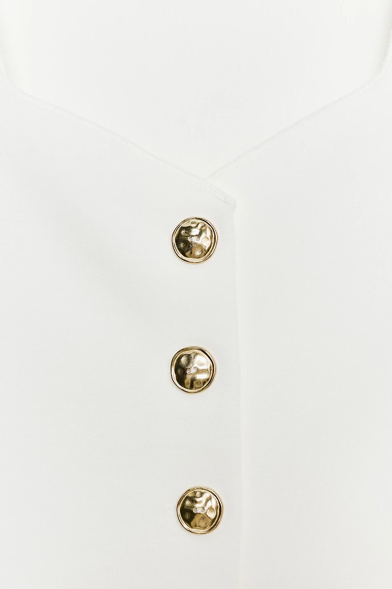 TOP PÉPLUM À BOUTONS