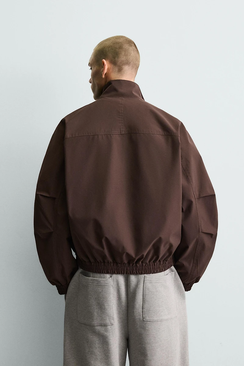 BLOUSON TECHNIQUE COUPE BOXY DÉPERLANT