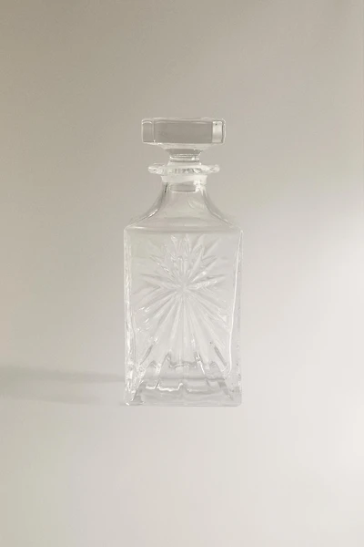 CRYSTALLINE BOTTLE WITH RAISED DESIGN