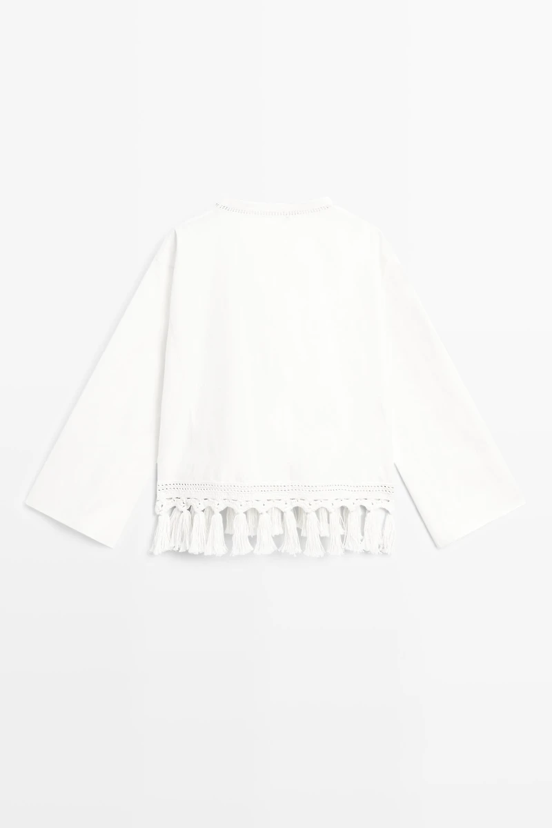 Embroidered blouse with fringed hem