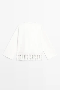 Embroidered blouse with fringed hem