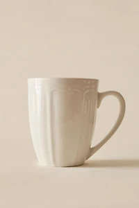 PORCELAIN MUG WITH RAISED DESIGN