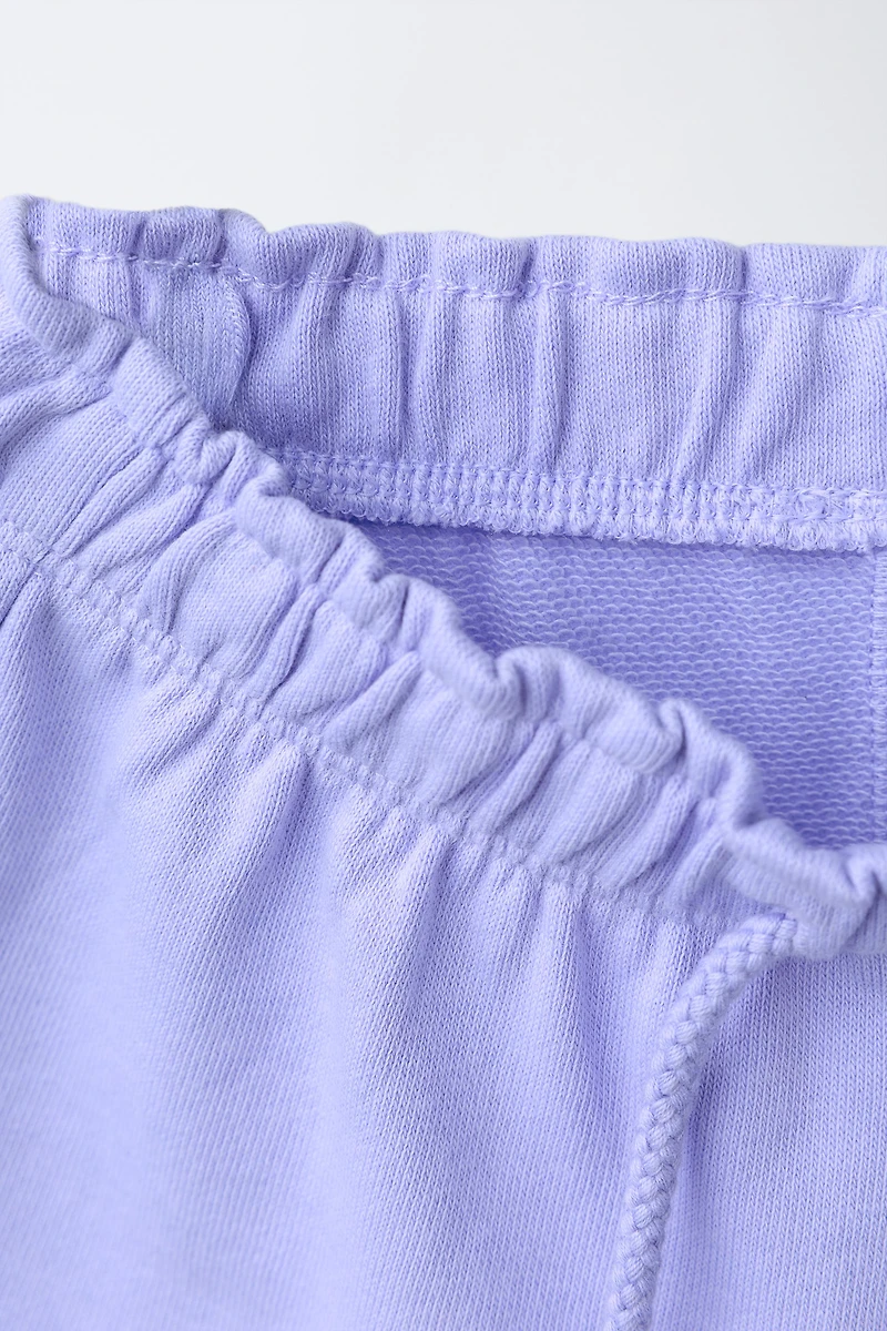RUBBERIZED APPLIQUÉ PLUSH SHORTS