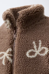 FAUX SHEARLING JACKET WITH BOW PRINT