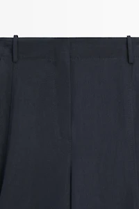 Flowing linen blend pants with buttoned tab detail