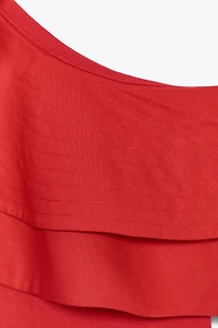 ASYMMETRIC BODYSUIT WITH CONTRASTING RUFFLE