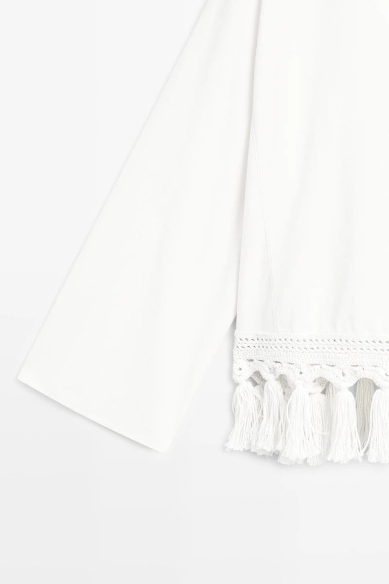 Embroidered blouse with fringed hem