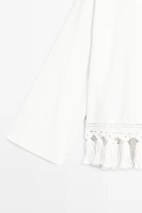 Embroidered blouse with fringed hem