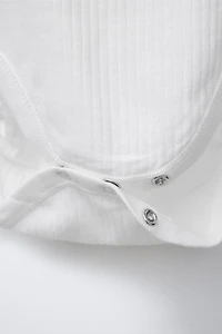 THREE-PACK OF SLEEVELESS BODYSUITS