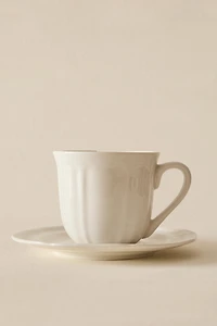 PORCELAIN TEACUP WITH SAUCER AND RAISED DESIGN