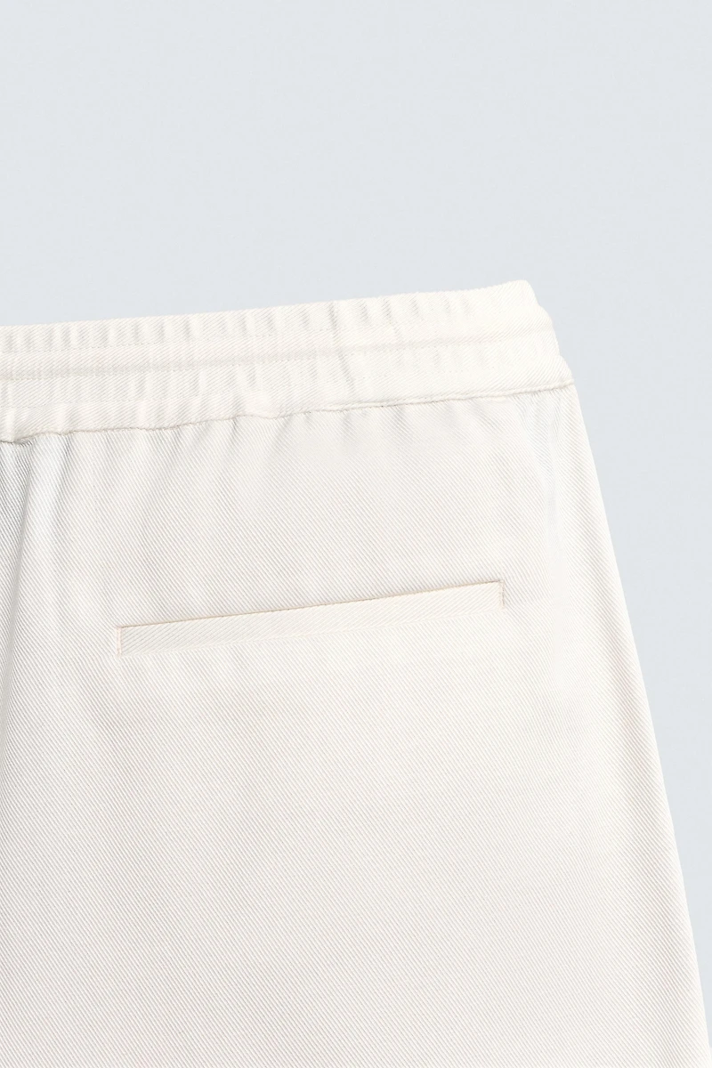 TEXTURED PLEATED PANTS