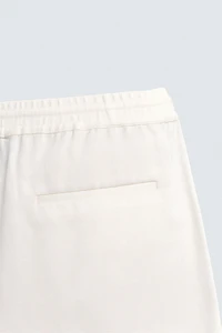 TEXTURED PLEATED PANTS