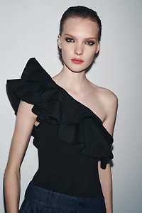 ASYMMETRIC BODYSUIT WITH CONTRASTING RUFFLE