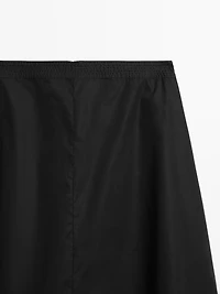 Jupe midi taille marquée