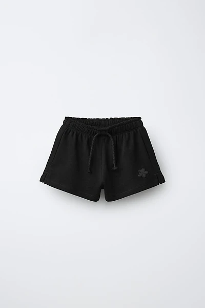 RUBBERIZED APPLIQUÉ PLUSH SHORTS