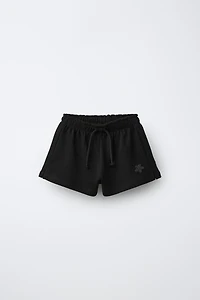 RUBBERIZED APPLIQUÉ PLUSH SHORTS