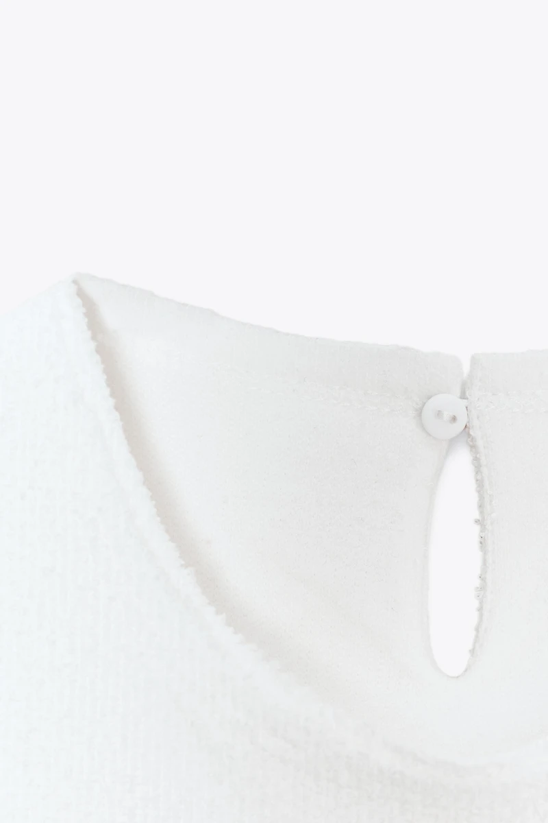 TOP PÉPLUM BOUCLE À