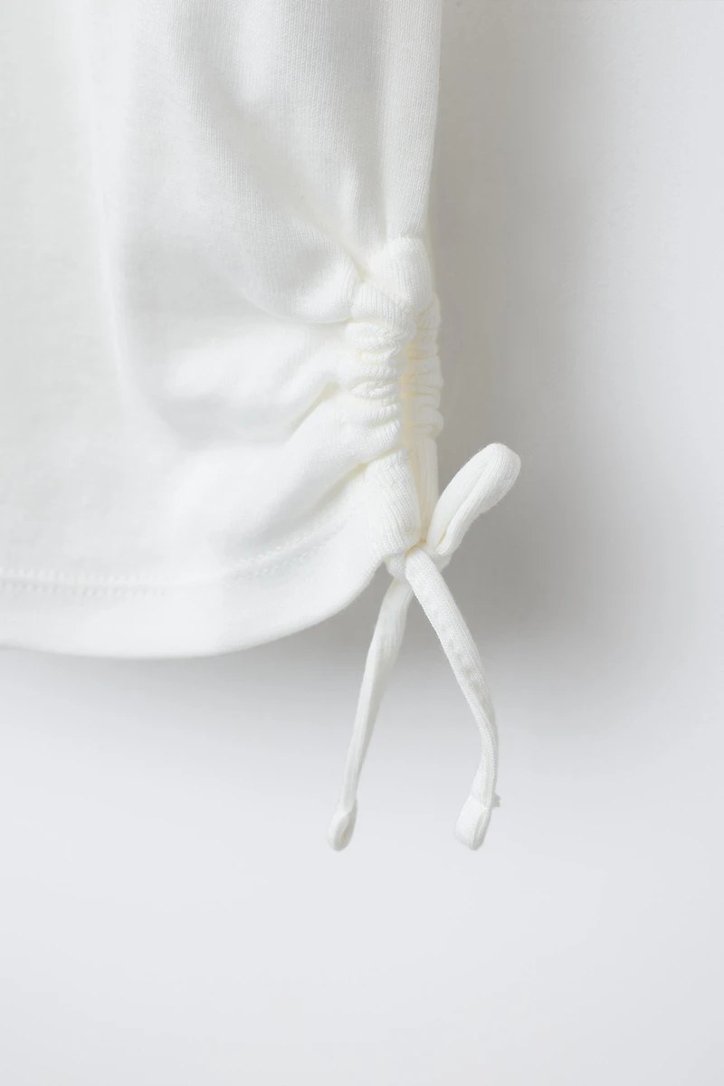 MODAL T-SHIRT WITH CUT OUTS AND BOWS