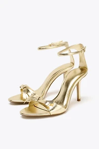 METALLIC EFFECT BOW HEELED SANDALS
