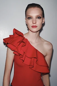 ASYMMETRIC BODYSUIT WITH CONTRASTING RUFFLE