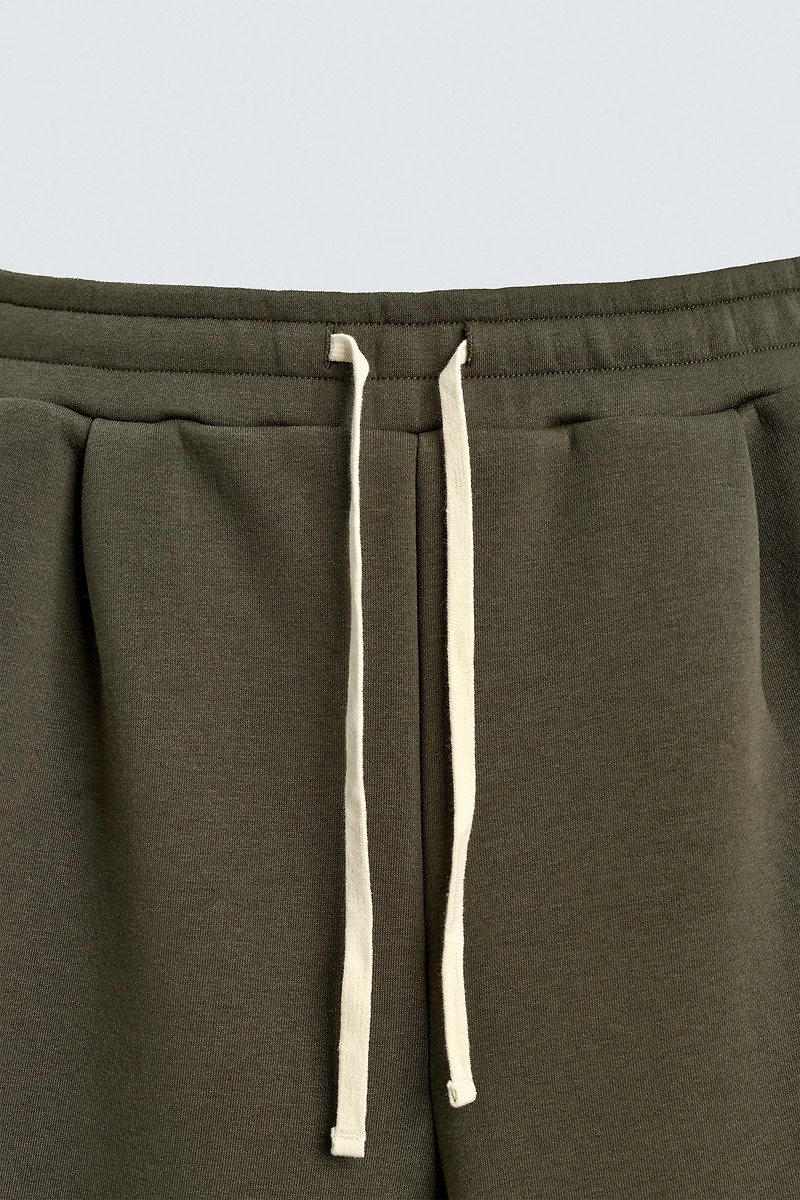 WIDE FIT NEOPRENE EFFECT PANTS WITH STUDS