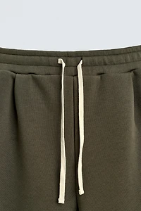 WIDE FIT NEOPRENE EFFECT PANTS WITH STUDS