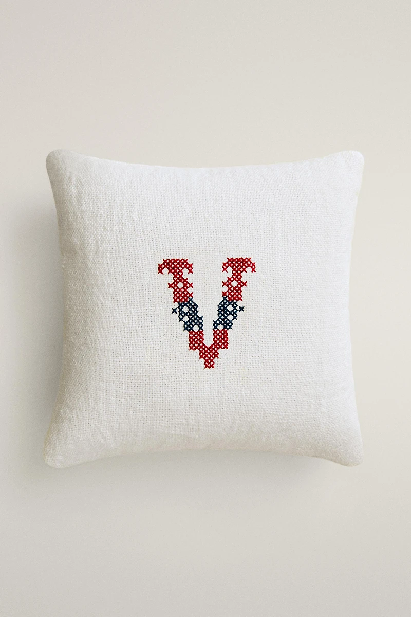 EMBROIDERED 'V' LETTER LINEN CUSHION