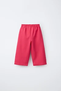 WIDE LEG INTERLOCK RAISED TEXT PANTS