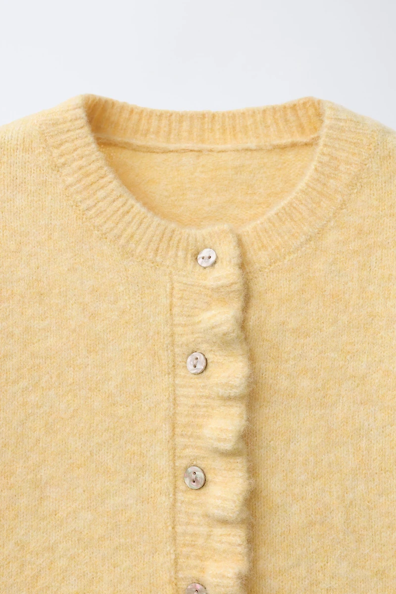 GILET EN MAILLE VOLANTS AVEC LAINE