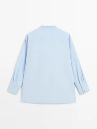 Shirt with stand collar and bib