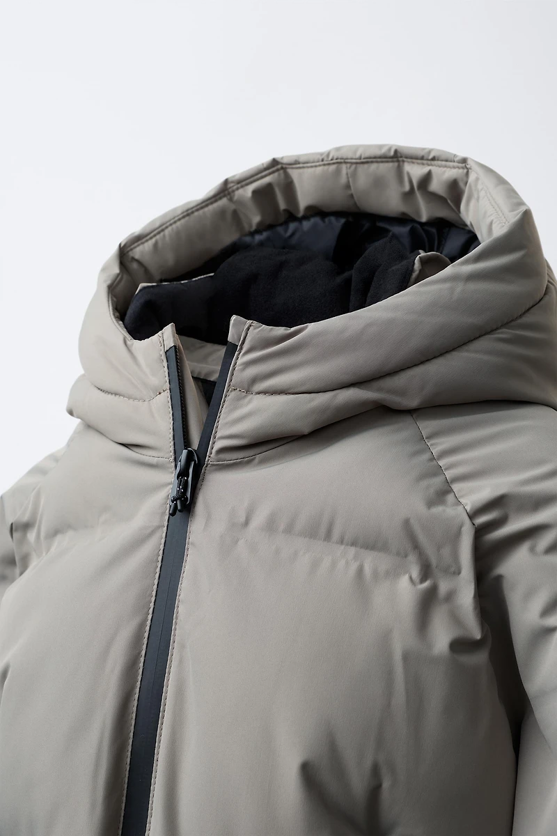 MANTEAU MATELASSÉ ZIPS DÉPERLANT
