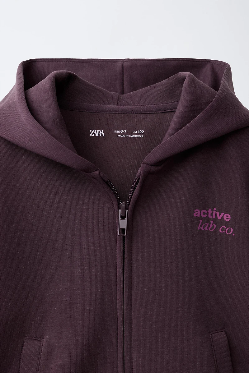 VESTE DE SPORT À CAPUCHE
