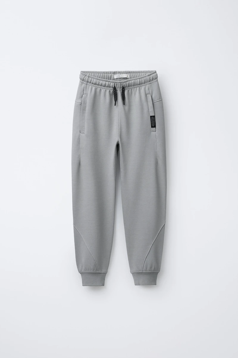 PANTALON EN MOLLETON INTERLOCK ET PIQUÉ
