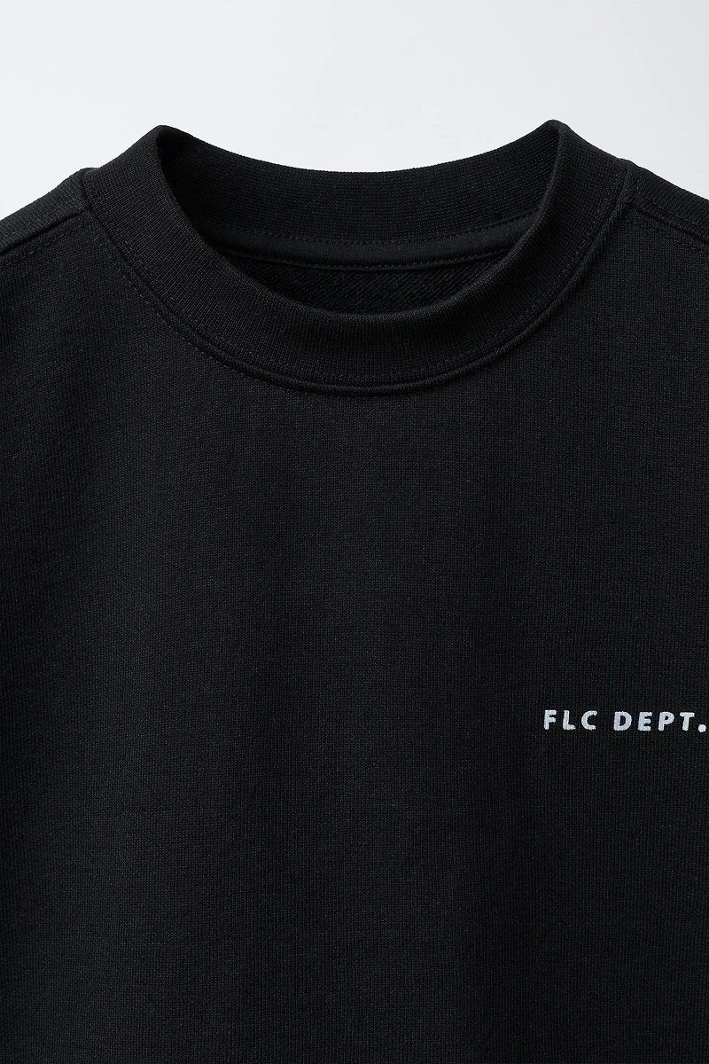 SHORT SLEEVE RAISED TEXT SWEATSHIRT