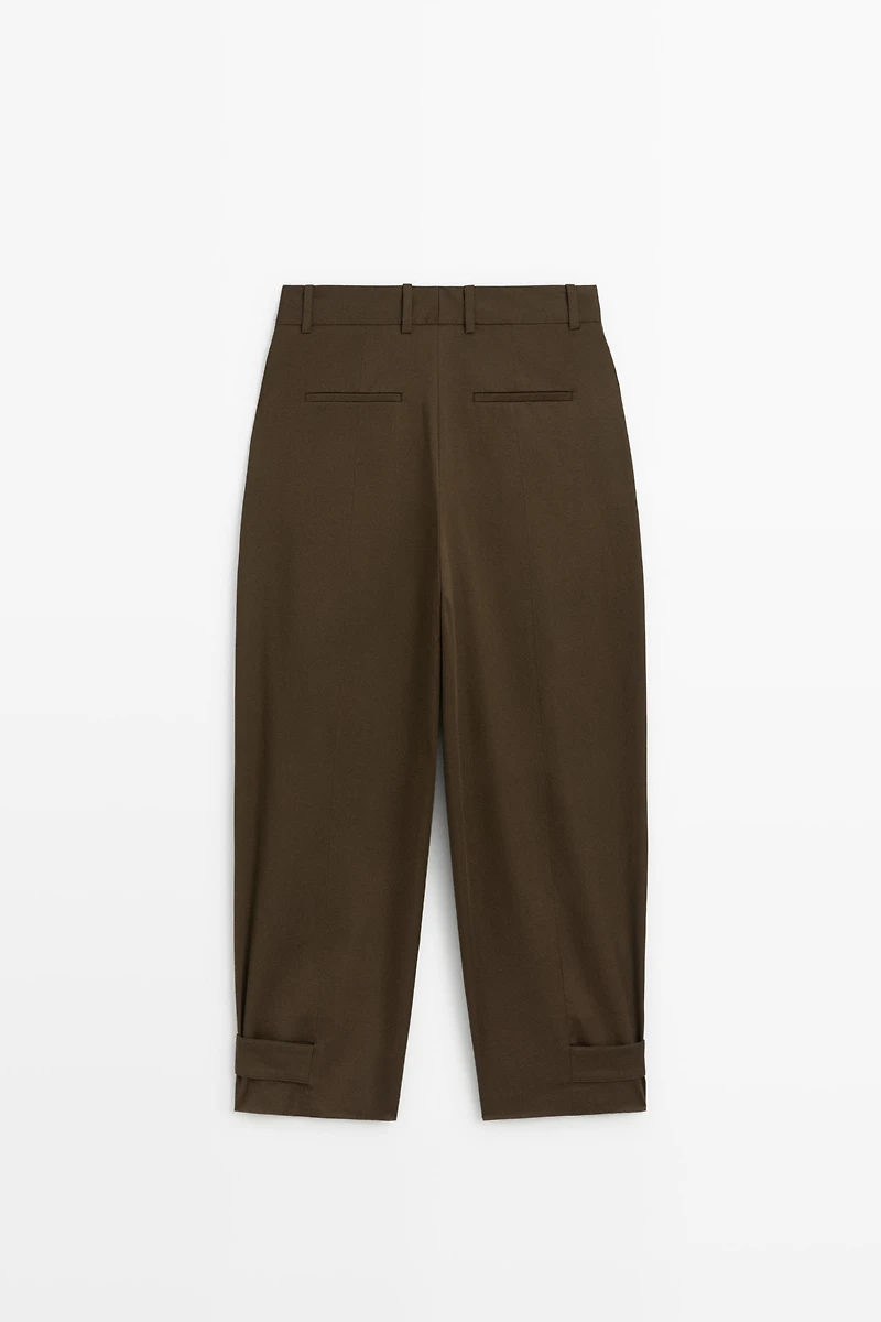 Pants with buttoned hem detail