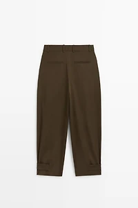 Pants with buttoned hem detail