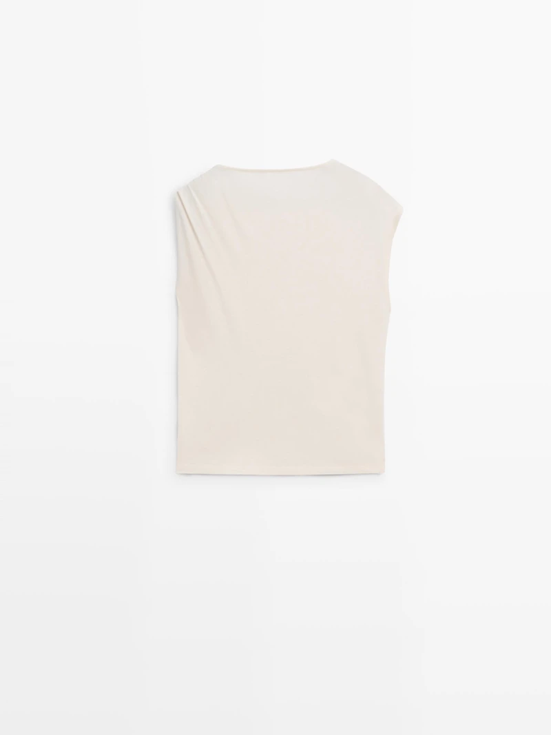 Asymmetric top with shoulder appliqué