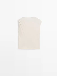 Asymmetric top with shoulder appliqué