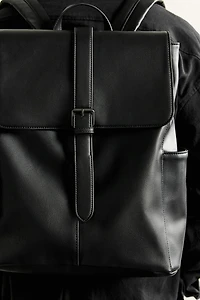 BELTED FLAP BACKPACK