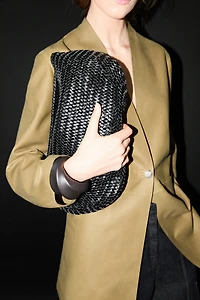 Braided leather half-moon bag