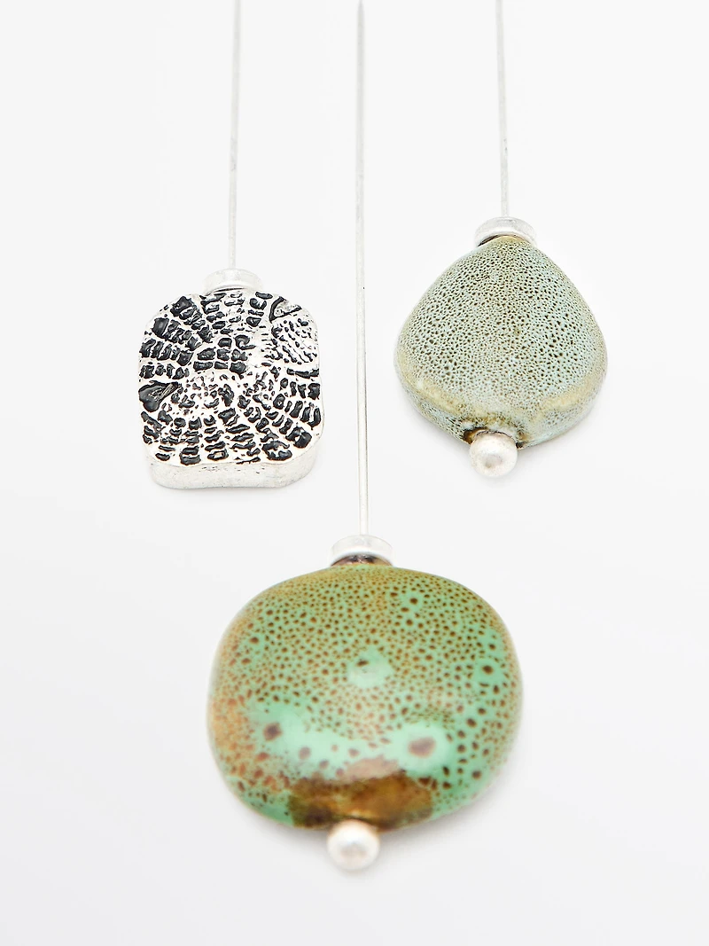 Brooch with textured ceramic piece and medallion