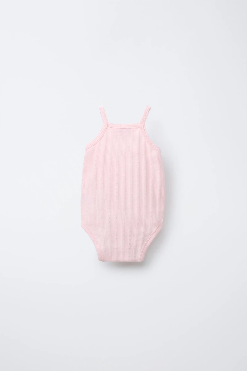 THREE-PACK OF RIB KNIT BODYSUITS WITH CUTOUT DETAIL