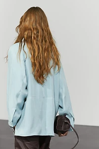 Flowing shirt with high collar and drawstring detail