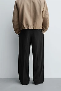 TEXTURED PLEATED PANTS